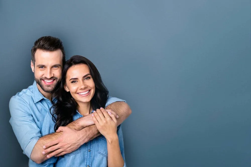 Patient smiling after dental implants at Laudenbach Periodontics