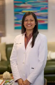 Laudenbach Periodontics female dentist in white coat, professional portrait