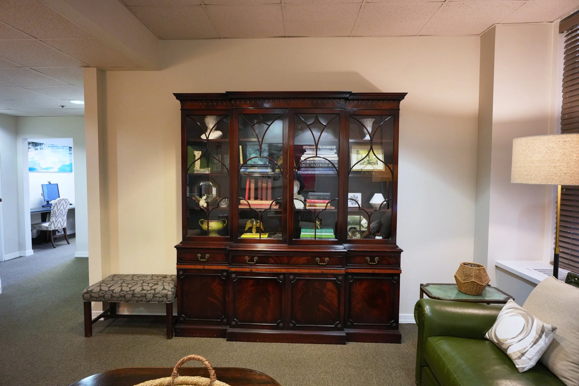 Laudenbach Periodontics office waiting area with dark wood cabinet and furniture