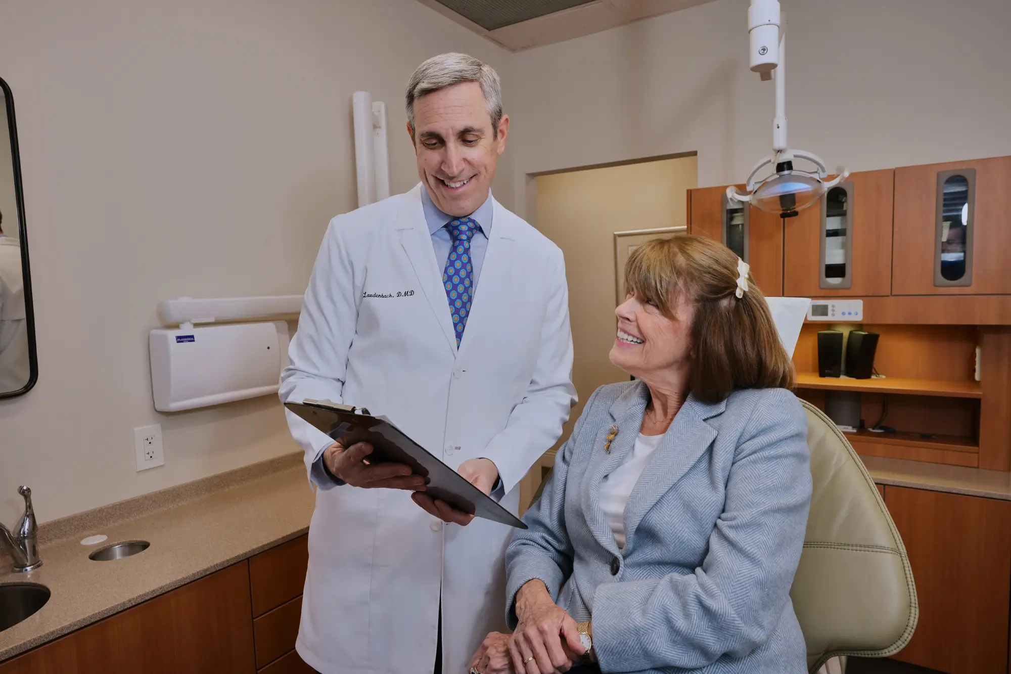 Laudenbach Periodontics dentist reviewing treatment plan with patient in operatory