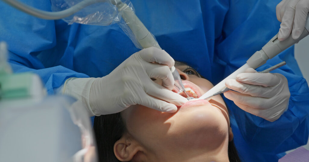 Patient undergoing dental scaling treatment at a periodontal office