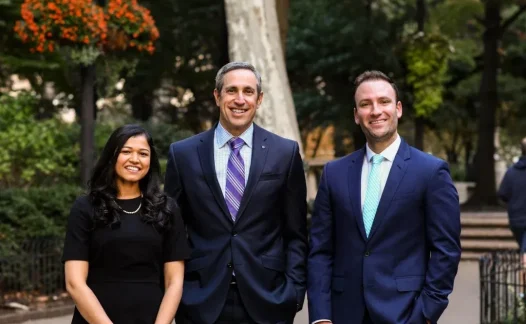 Laudenbach Periodontics & Dental Implants team of three dental professionals outdoors
