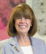 Professional headshot of woman smiling in business attire