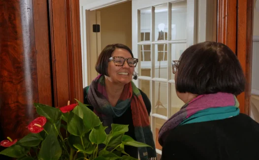 Laudenbach Periodontics staff member greets patient in reception area
