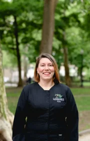 Laudenbach Periodontics & Dental Implants team member Katie in black scrubs outdoors