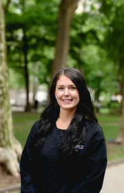Laudenbach Periodontics & Dental Implants team member Theresa in black scrubs outdoors